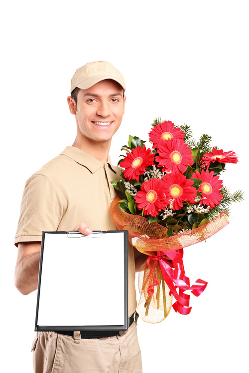 Delivery boy delivering bouquet of flowers and holding a clipboa